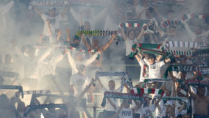WARSAW, POLAND - AUGUST 23: Supporters of Legia Warsaw sing during Legia Warsaw v Dundalk FC - UEFA Champions League Play Off 2nd Leg at the Wojsko Polskie Stadium on August 23, 2016 in Warsaw, Poland. (Photo by Adam Nurkiewicz/Getty Images)